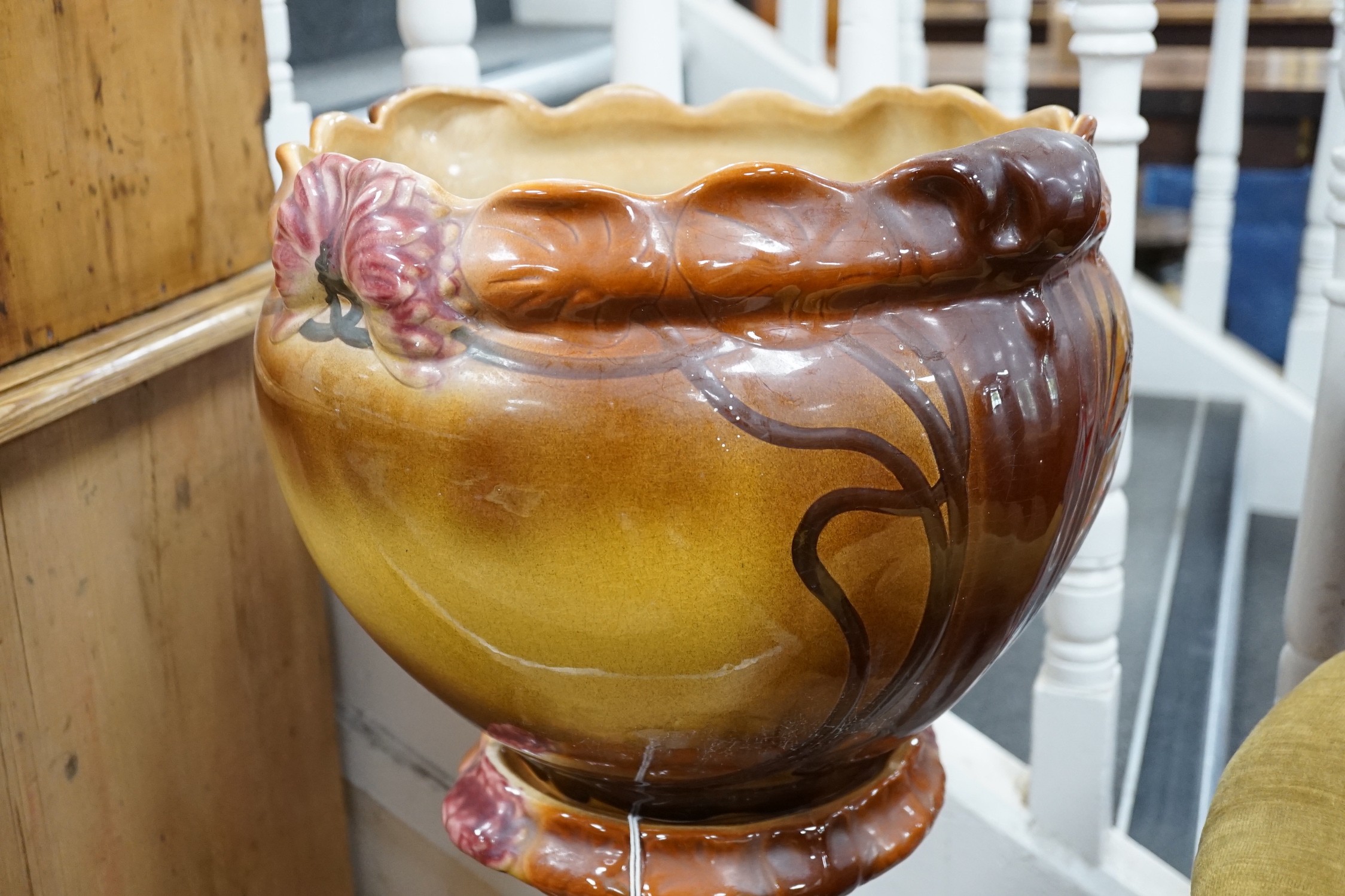 An Art Nouveau style earthenware jardiniere on pedestal. 93cm tall